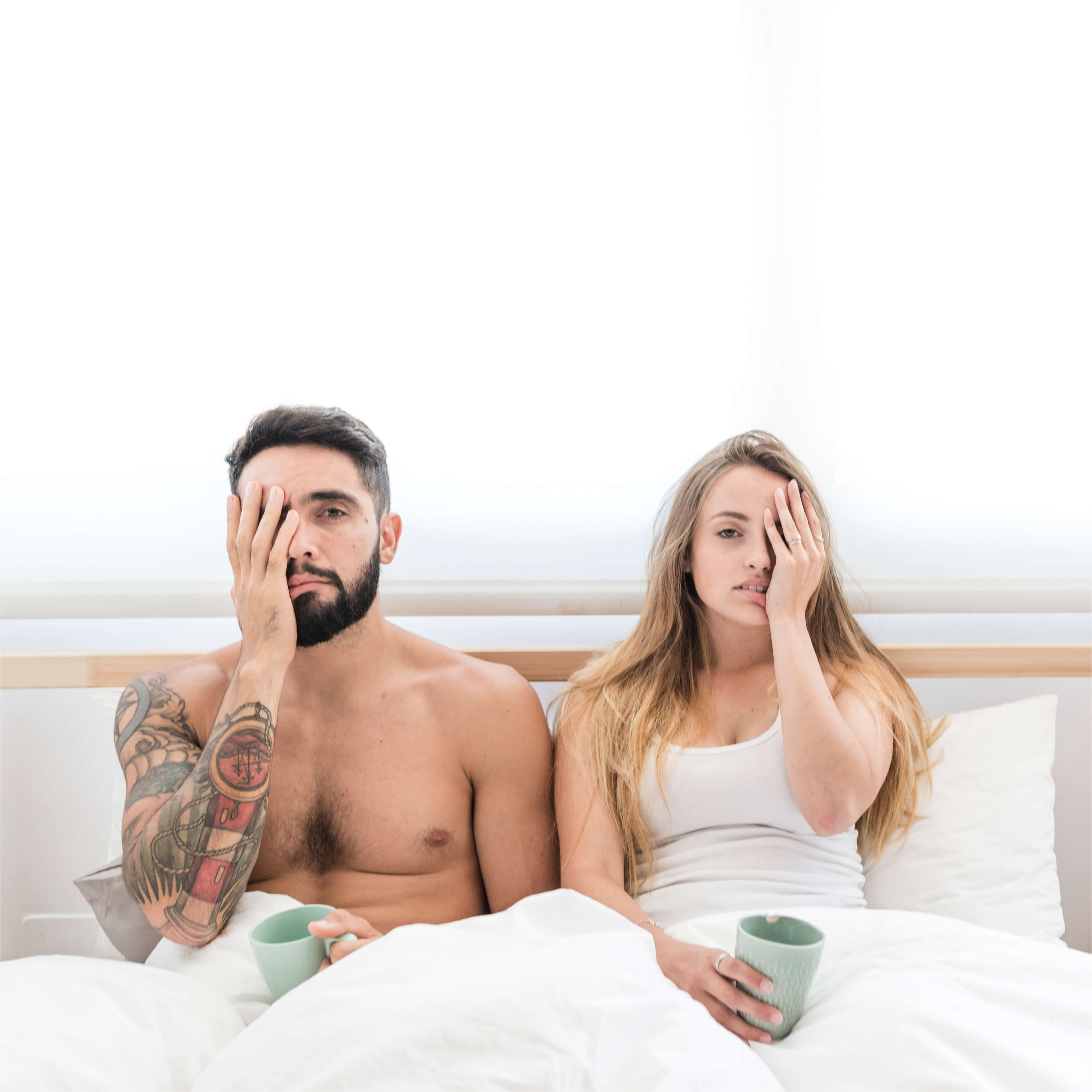 young-couple-sitting-bed-covering-their-one-eye (1)(1)(1)
